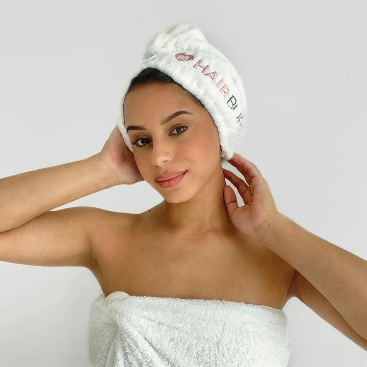 Woman with a white Hairburst microfibre hair towel wrapped around her head
